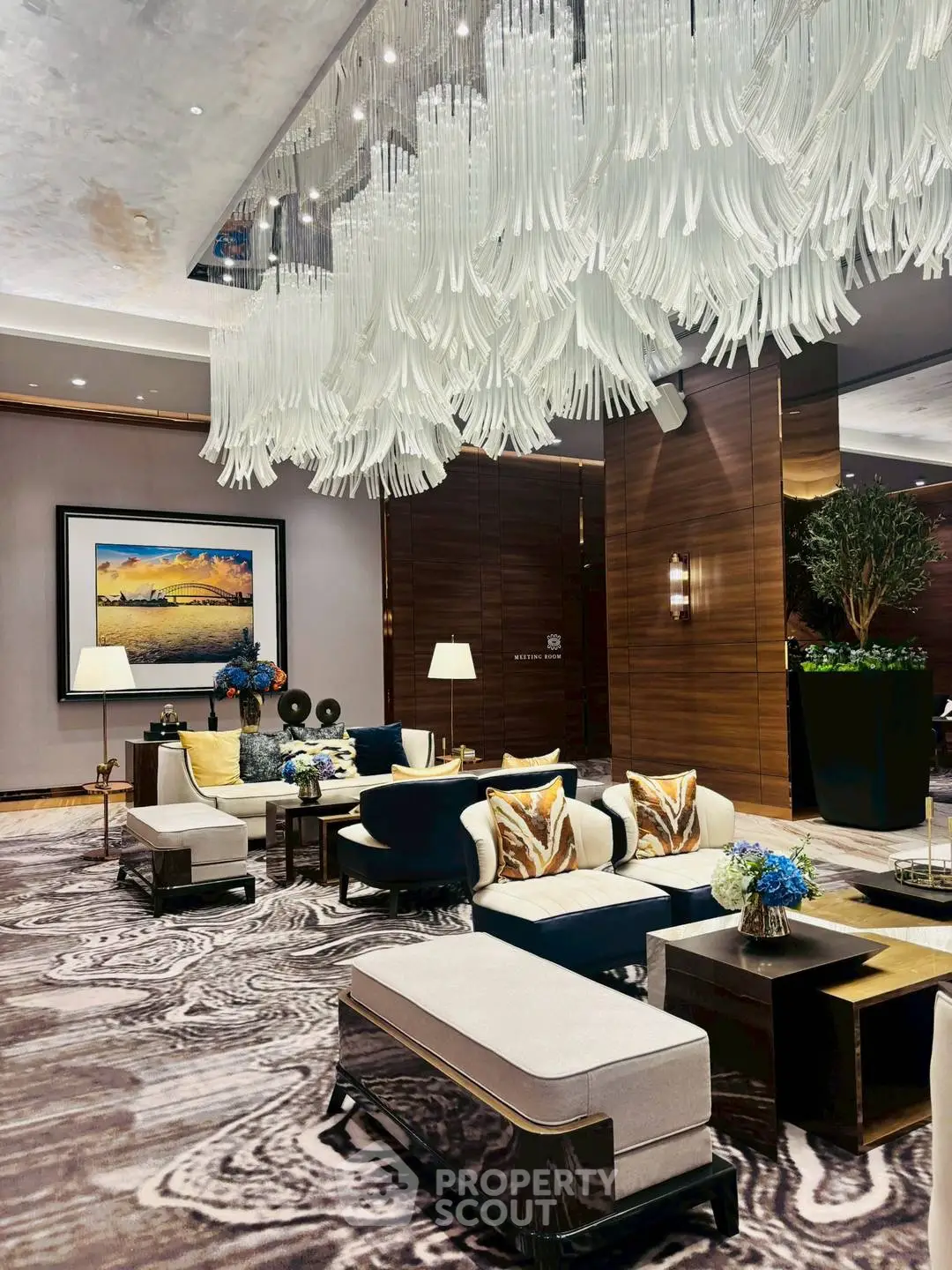 Luxurious living room with elegant chandelier and modern decor in upscale property.