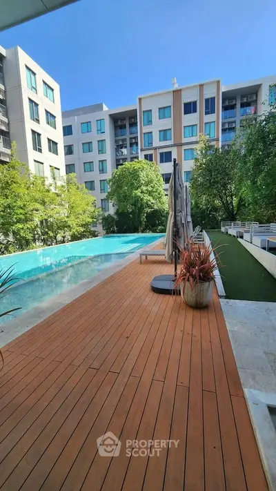 Luxurious apartment complex with stunning pool and lush greenery, perfect for relaxation and leisure.