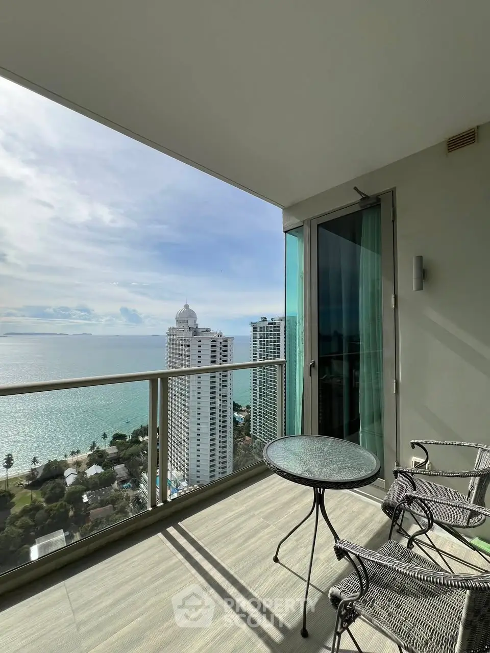 Stunning balcony view overlooking ocean and cityscape, perfect for relaxation.