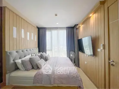 Luxurious bedroom with modern decor and large window offering stunning views.