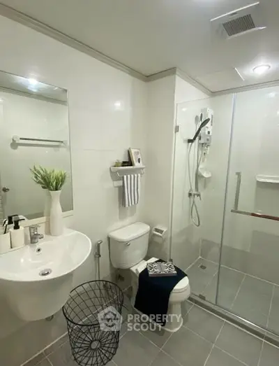 Modern bathroom with glass shower, sleek sink, and stylish decor