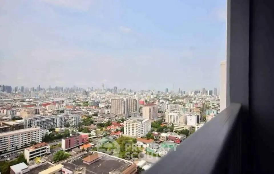 Stunning cityscape view from high-rise balcony showcasing urban skyline.