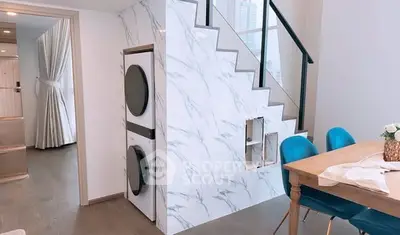 Modern interior with stylish staircase and dining area in a contemporary home.