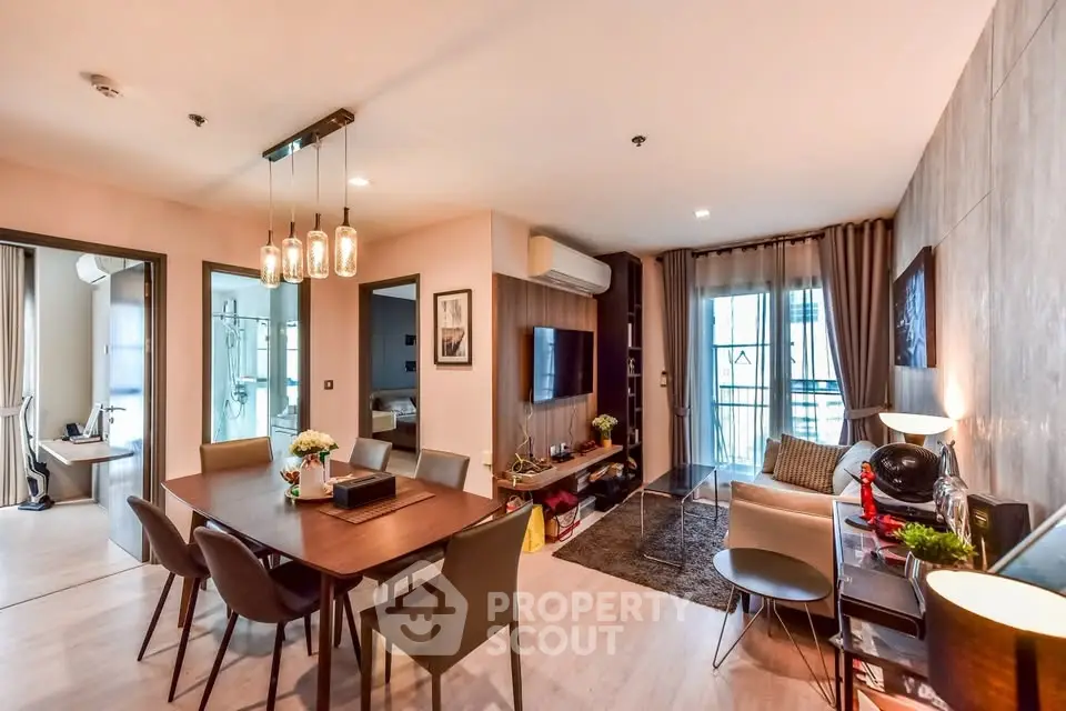 Modern living room with dining area, stylish decor, and natural light in a contemporary apartment.