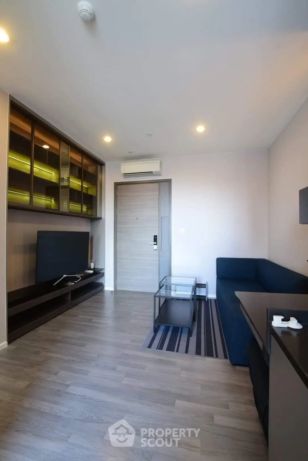 Modern living room with sleek furniture and wooden flooring