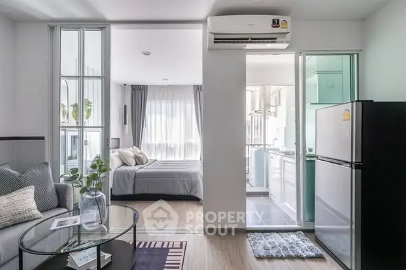 Modern open-plan apartment with cozy living area and sleek kitchen