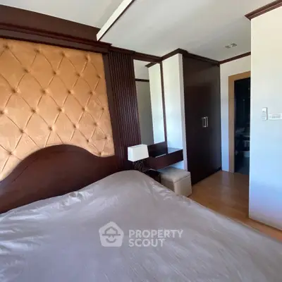 Luxurious bedroom with elegant headboard and modern wooden wardrobe