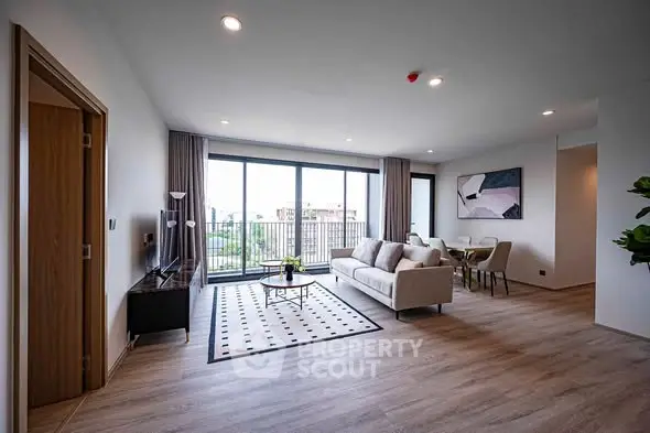 Spacious modern living room with large windows and stylish decor