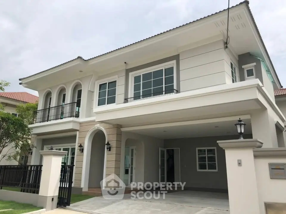 Stunning two-story modern house with elegant facade and spacious driveway.