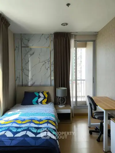 Modern bedroom with balcony access and stylish decor in a high-rise apartment.