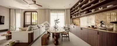 Luxurious living room with elegant decor and natural light, featuring a stylish sofa and modern shelving.