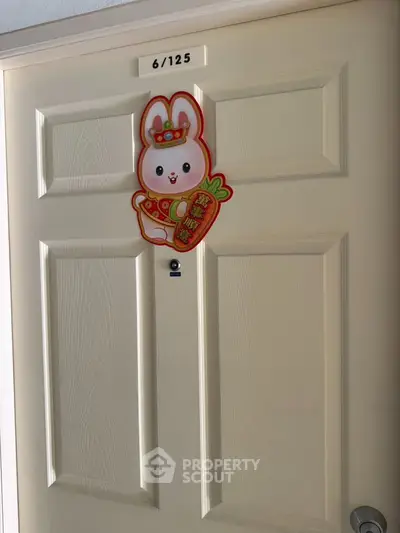 Charming apartment door with festive rabbit decoration, perfect for welcoming guests in style.