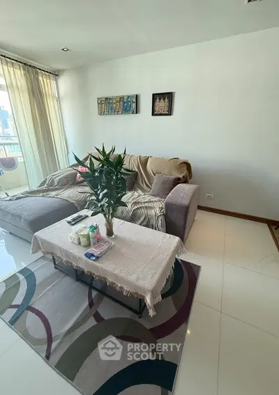 Modern living room with cozy sofa and stylish decor in a bright apartment.