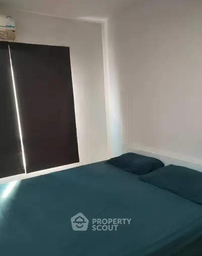 Cozy bedroom with dark curtains and minimalist design, perfect for restful nights.