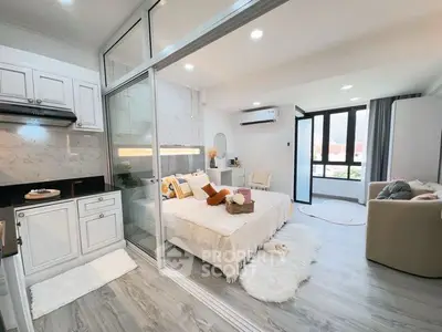 Modern studio apartment with open layout, featuring a cozy bedroom and stylish kitchen.