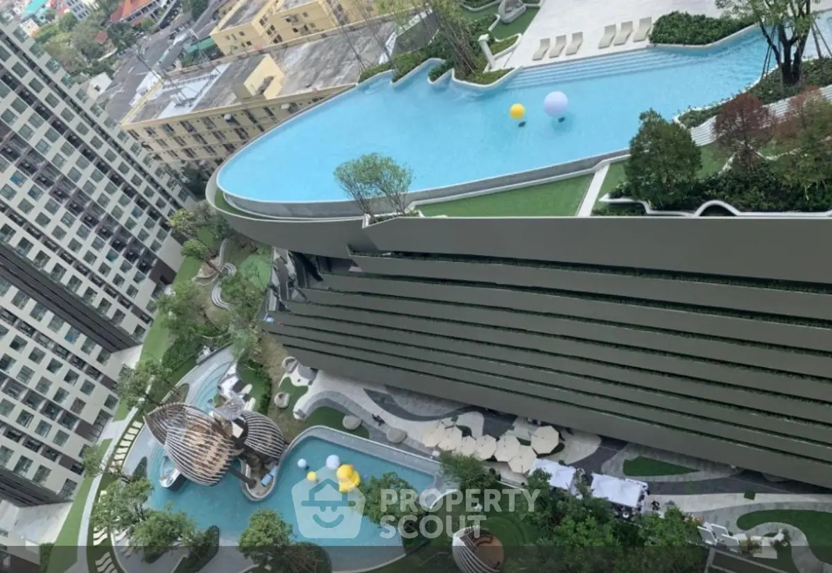 Luxurious high-rise building with stunning rooftop pool and lush garden views.