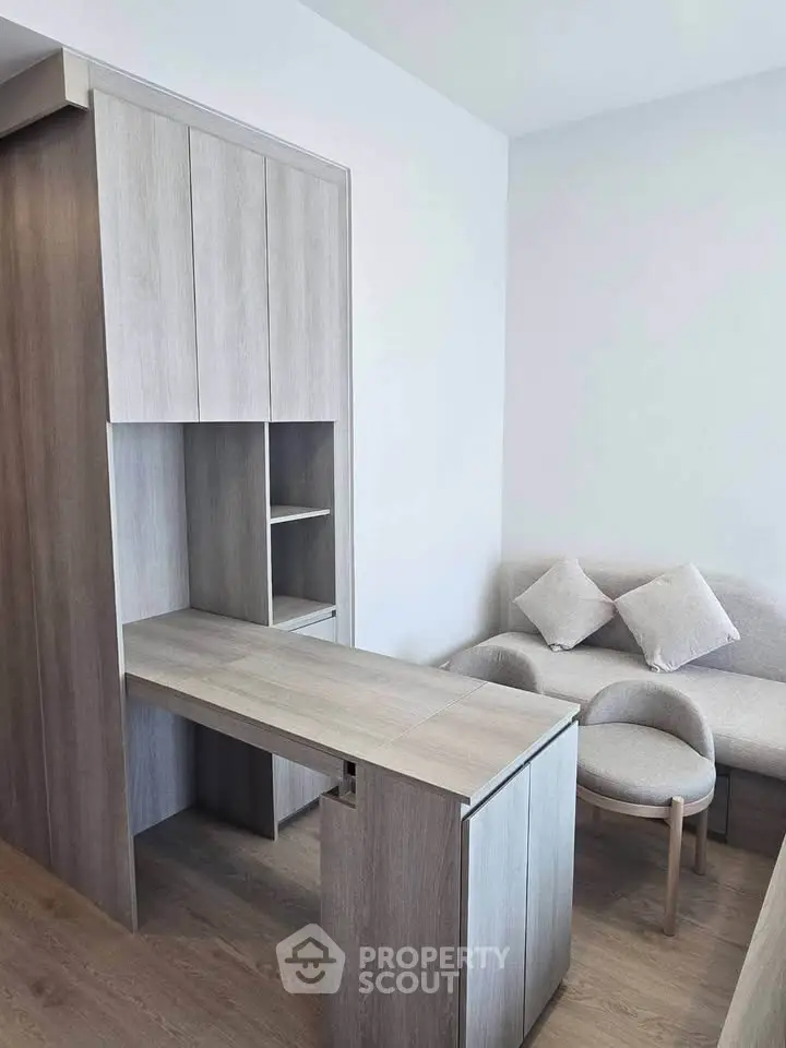 Modern living room with sleek wooden furniture and cozy seating area.