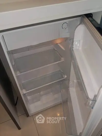 Modern kitchen with sleek under-counter refrigerator, perfect for compact spaces.