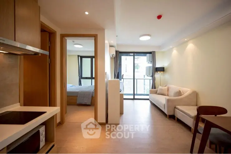 Modern apartment interior with open layout, featuring cozy living room and bedroom with natural light.