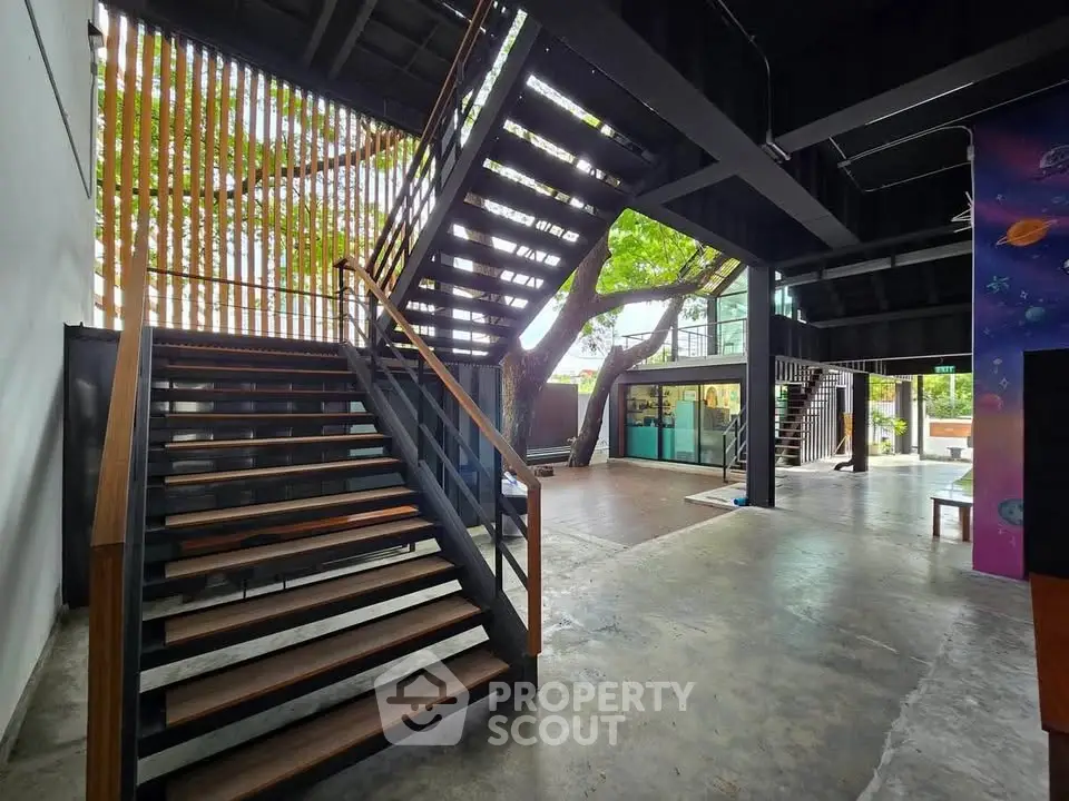 Modern open space with industrial staircase and natural light