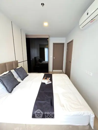Modern bedroom with sleek design and air conditioning in a stylish apartment