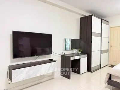 Modern bedroom with sleek TV setup and stylish wardrobe