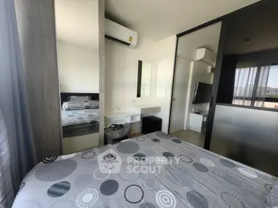 Modern bedroom with stylish decor and mirrored wardrobe in a cozy apartment.