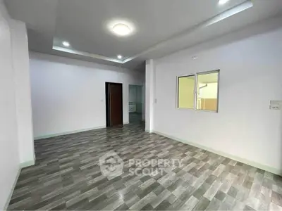 Spacious modern living room with sleek flooring and recessed lighting