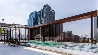 Luxurious rooftop pool with stunning city skyline views in modern high-rise building.