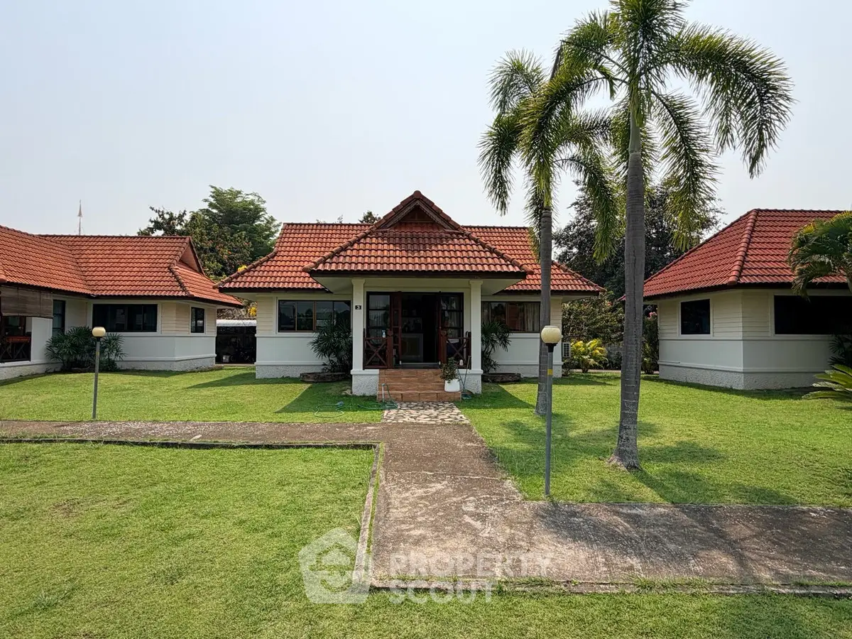 Charming bungalow with red-tiled roof and lush green lawn