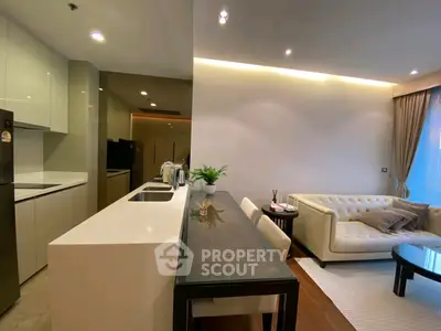 Modern open-layout kitchen and living room with sleek design and elegant furnishings.