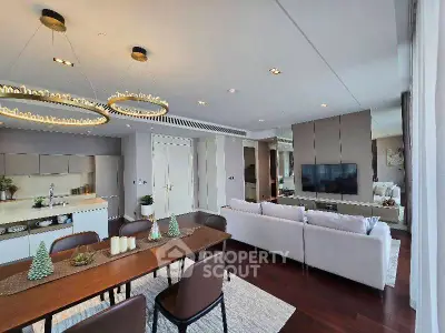 Luxurious open-plan living room with elegant dining area and modern kitchen in upscale apartment.
