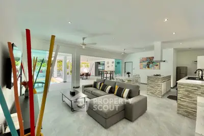 Spacious open-plan living room with modern decor and pool view