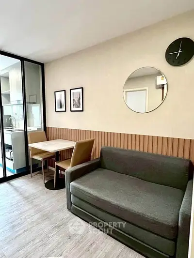 Modern living room with stylish decor and cozy seating area in a contemporary apartment.