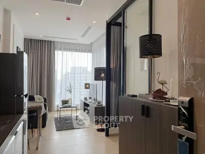 Modern living room with elegant decor and city view, featuring stylish furniture and natural light.