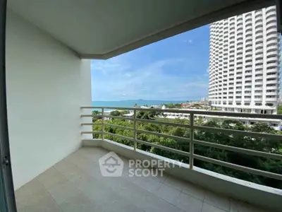 Spacious balcony with stunning ocean view in modern high-rise building