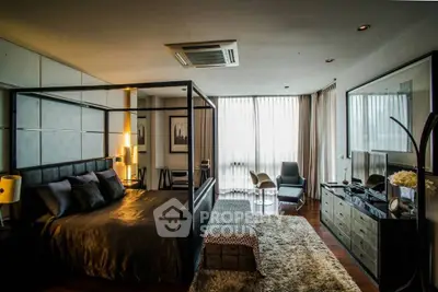 Luxurious bedroom with modern decor and large windows for natural light.
