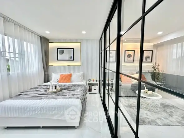 Modern bedroom with glass partition and stylish decor