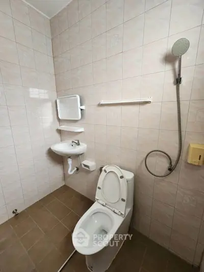 Compact bathroom with tiled walls and modern fixtures