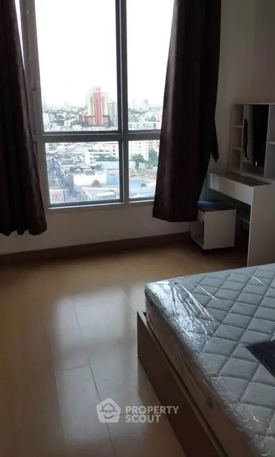 Spacious bedroom with city view and natural light in modern apartment