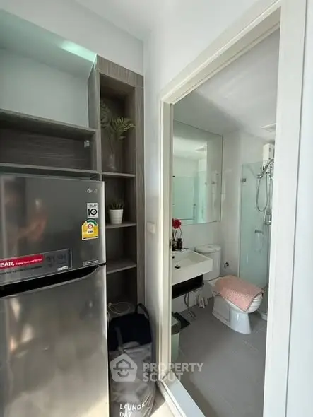 Modern compact apartment with sleek kitchen and stylish bathroom, perfect for urban living.