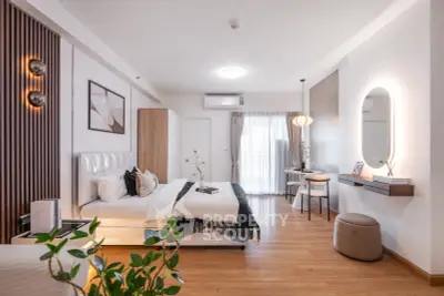 Spacious modern bedroom with elegant decor and natural light