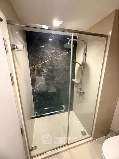 Modern bathroom with glass shower enclosure and sleek tile design