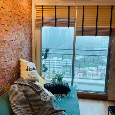 Cozy living room with brick wall and city view from balcony, perfect urban retreat.