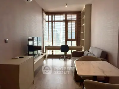 Modern living room with city view, featuring sleek furniture and natural light.