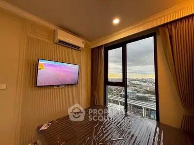 Modern bedroom with city view, wall-mounted TV, and air conditioning in a high-rise apartment.