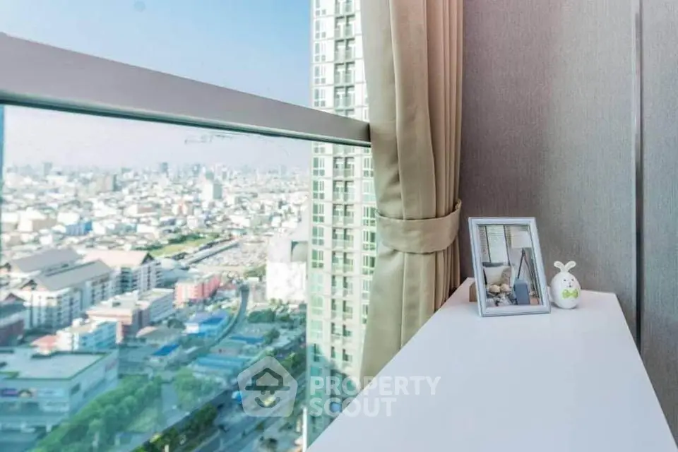 Stunning city view from high-rise apartment window with modern decor.
