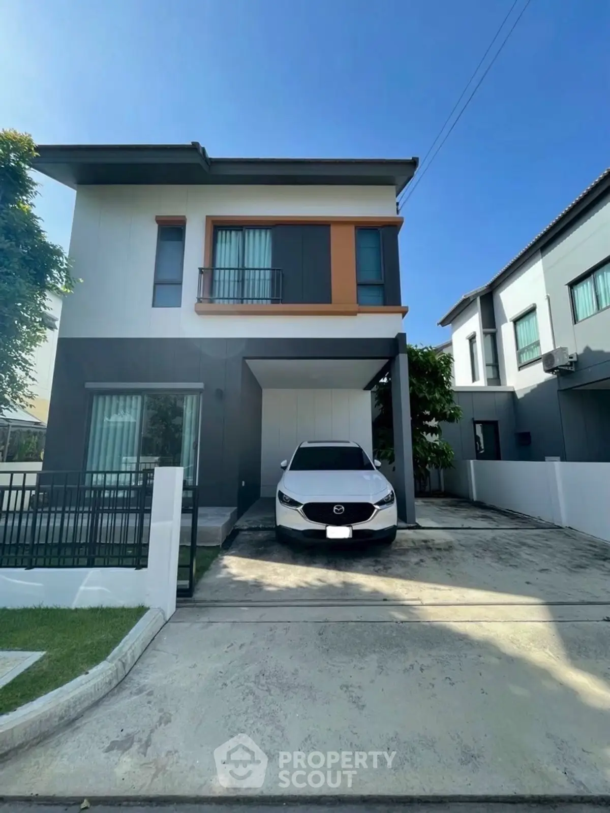 Modern two-story house with carport and sleek exterior design
