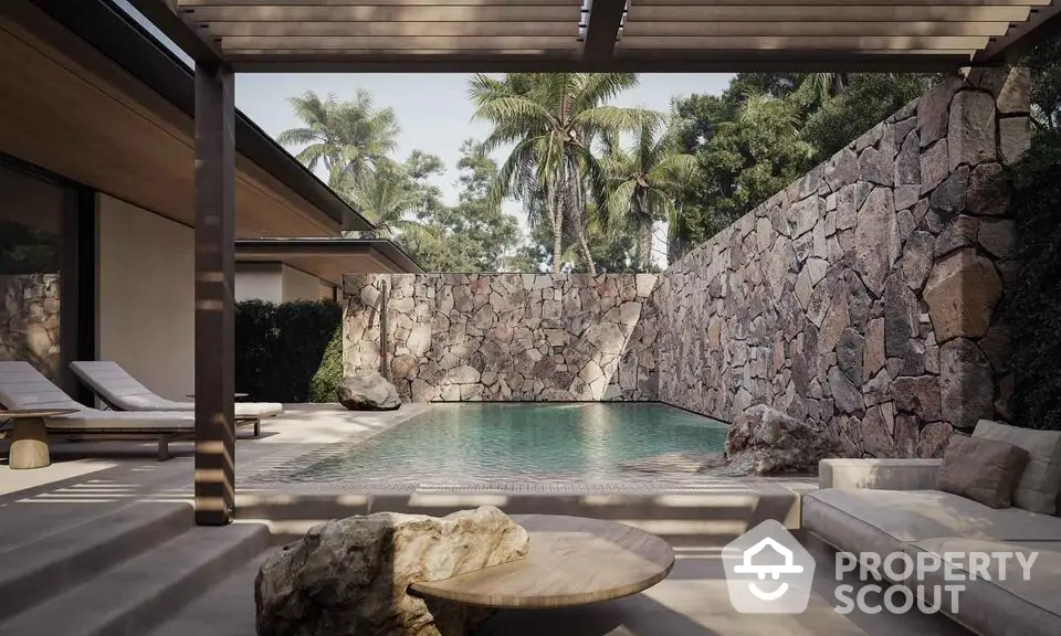 Luxurious private pool with stone wall and tropical landscaping