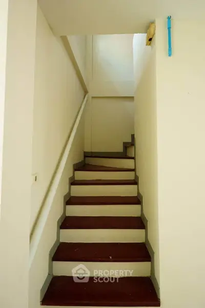 Simple staircase in a residential building with clean lines and neutral colors.